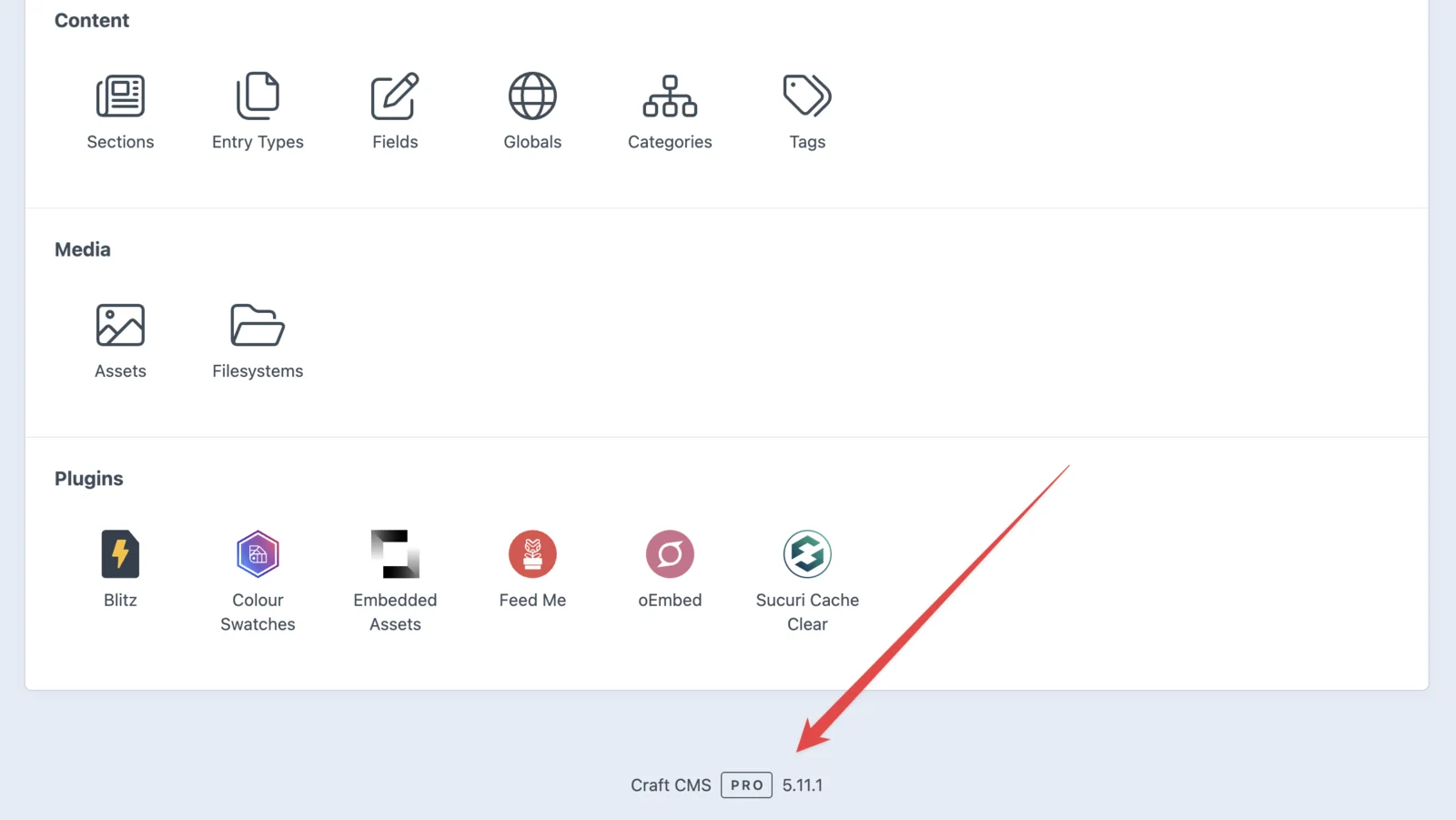 The Settings page of a Craft CMS control panel, with an arrow pointing to the footer, which reads Craft CMS Pro 5.11.1.